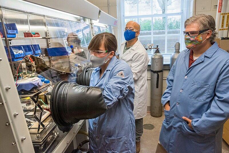 Graduate student Amanda Weaver (left) sets the UD-developed electrochemical process in motion, while chemistry professors Eric Bloch (center) and Joel Rosenthal (right) observe.